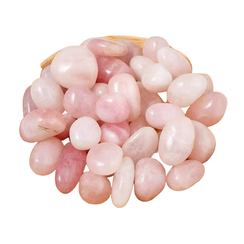 Pink crystal stones in a wooden bowl on a white background