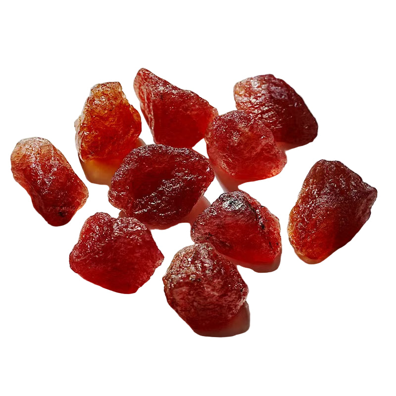 Red dried fruits on a white plate with a white background