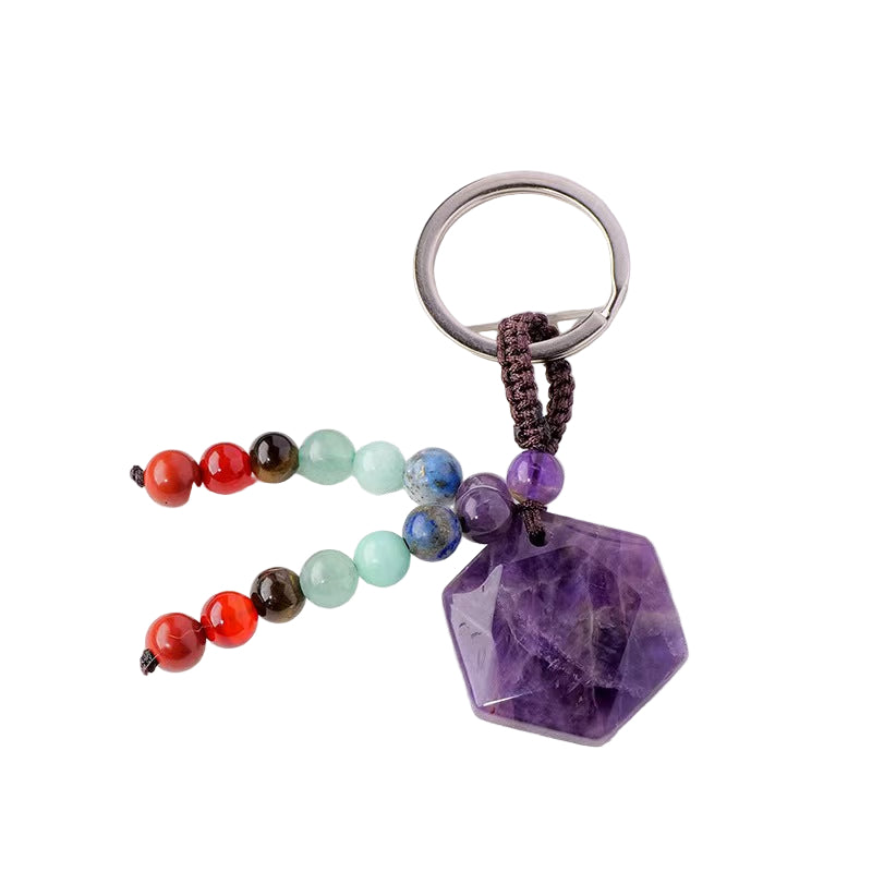 Keychain with colorful beads and a purple crystal pendant on a white surface.