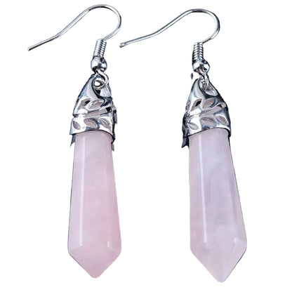Pink crystal earrings with silver tops on a black background