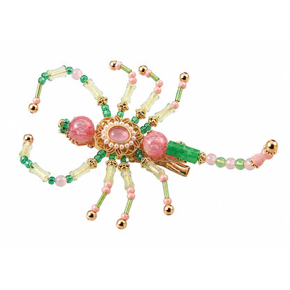 Pink green beaded scorpion hair clip with gold-tone accents and pearl-like center trim